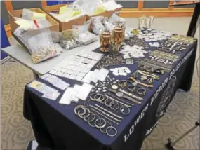  ??  ?? Recovered items line tables at the press conference at the Lower Merion Township Building druing a press conference Thursday, March 16, 2017. The search recovered approximat­ely 50,000 pieces of jewelry, coins and precious metals.