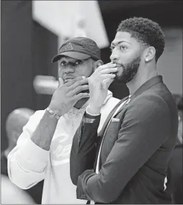  ?? [DAMIAN DOVARGANES/THE ASSOCIATED PRESS] ?? Anthony Davis, right, is joined by Lakers teammate Lebron James after Davis was introduced at a news conference on Saturday.