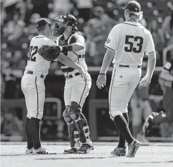  ?? John Peterson/Associated Press ?? Texas A&M pitcher Brad Rudis, left, and catcher Troy Claunch celebrate Sunday’s victory over Texas that sends the Aggies into another do-or-die game against Notre Dame on Tuesday.