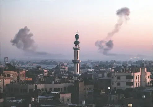  ?? SAID KHATIB / AFP VIA GETTY IMAGES ?? A picture taken from Rafah shows smoke billowing during Israeli bombardmen­t over Khan Younis this week. Rafah would be the next major target of the Israeli offensive, but criticism of the potential impact on civilians is mounting.