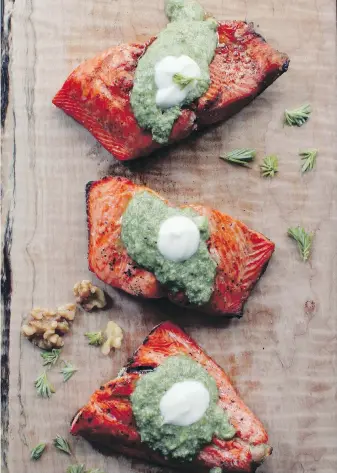  ??  ?? Wild salmon is grilled and topped with a tree tip pesto in this recipe from Feast: Recipes & Stories From A Canadian Road Trip (Appetite by Random House, $35).