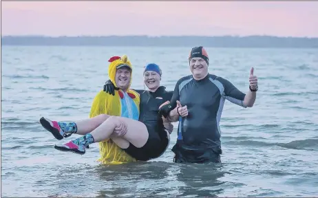  ?? Pictures: Mike Cooter (010122) ?? CHILLY DIPPERS Timothy Angel, Meryl Walker and Jonnie Angel from #Vitamin_Sea_Gosport during their dawn swim at Stokes Bay. Below: Joey Duffy, Joe Small and Mia the dog