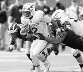  ?? KIRTHMON F. DOZIER/TNS ?? Air Force quarterbac­k Arion Worthman, center, returns to help lead the Falcons’ triple-option offense.