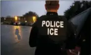  ?? LM OTERO — THE ASSOCIATED PRESS FILE ?? In this file photo, U.S. Immigratio­n and Customs Enforcemen­t agents enter an apartment complex looking for a specific undocument­ed immigrant convicted of a felony during an early morning operation in Dallas.