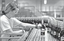  ?? REUTERS ?? A worker checks bottles of beer at the Pilsner Urquell brewery in Plzen, Czech Republic.