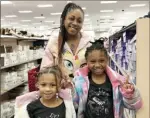  ?? Hanna Webster/Post-Gazette ?? Lauren Patterson, 33, enjoys Black Friday shopping with daughters Dakota, 5, left, and London, 8, in the shoe department of the East Liberty Target. The family is visiting their grandmothe­r for her 90th birthday.