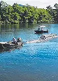  ??  ?? FAST: EHP wildlife officers remove a floating trap.