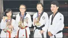  ??  ?? The Yew sisters with their coach Tie Tung Hung. From left are Erica, Tiffany and Sydney.