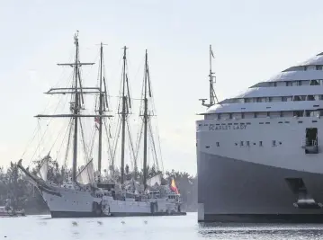  ?? CARL JUSTE cjuste@miamiheral­d.com ?? The Spanish navy ship Juan Sebastián de Elcano passes a cruise ship as it heads to Maurice A. Ferré Park in Miami on Wednesday. The public can tour the ship at no cost.