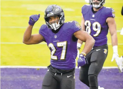  ?? KEVIN RICHARDSON/BALTIMORE SUN ?? Ravens running back J.K. Dobbins celebrates a touchdown in the second quarter Sunday against the Jaguars.