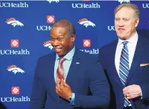  ?? DAVID ZALUBOWSKI/ASSOCIATED PRESS ?? Vance Joseph, left, smiles with general manager John Elway as he is introduced as the new head coach of the Broncos.