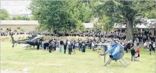  ?? PHOTO: SUPPLIED ?? Fond farewell . . . Mourners gather as two helicopter­s prepare to lift the casket of Cromwell teacher Anne Cook from Bendigo Station.