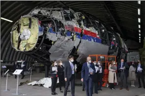  ?? (AP File/Peter Dejong) ?? Judges and lawyers view the reconstruc­ted wreckage of Malaysia Airlines Flight MH17 at the Gilze-Rijen military airbase, southern Netherland­s, on May 26, 2021. More photos at arkansason­line. com/1118mh17/.