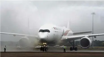  ?? — Bernama ?? On arrival: The first Malaysia Airlines A350-900 XWB arriving to a water salute at the KL Internatio­nal Airport yesterday.