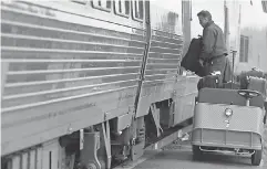  ?? TINA MACINTYRE - YEE/ USA TODAY NETWORK ?? During a stop in Rochester, N. Y., luiggage is removed from the Amtrak train.