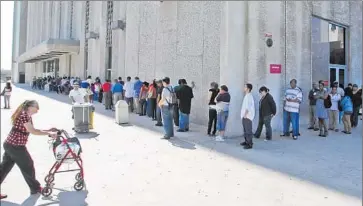  ?? Damian Dovarganes Associated Press ?? PEOPLE line up outside the Metropolit­an Courthouse, which handles traffic citations and other matters, in L.A. Some judges worry that a proposed rule will f lood the courts with people seeking trials on tickets.