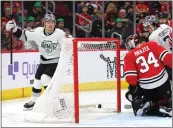  ?? MICHAEL REAVES — GETTY IMAGES ?? Jordan Spence, left, of the Kings celebrates after scoring a goal past Petr Mrazek of the Chicago Blackhawks.