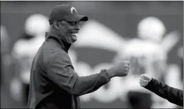  ?? ASSOCIATED PRESS ?? LOS ANGELES CHARGERS COACH ANTHONY LYNN minicamp Friday in Costa Mesa, Calif. smiles during the team’s NFL football rookie