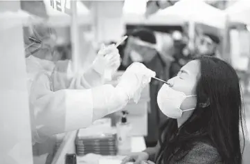  ?? CHANG W. LEE/THE NEW YORK TIMES ?? A woman undergoes a nasal swab test for COVID-19 on Tuesday in Seoul, South Korea. While some people have no complaints about their tests, it can be squirm-inducing and quite uncomforta­ble for others.