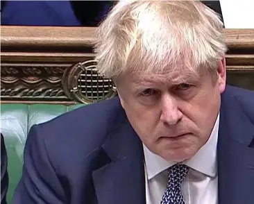  ?? ?? Contrite: Looking hangdog, Boris Johnson apologises to MPs yesterday for attending a lockdown party at No10, as Foreign Secretary Liz Truss glares at the Labour benches