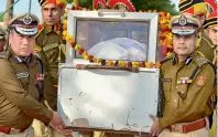  ?? PTI ?? Delhi Police Commission­er Amulya Patnaik, right, and other police officers carry the mortal remains of police inspector Ratan Lal at Shadeed Smarak Sthal in New Delhi on Tuesday,. Ratan Lal was among those killed in the violence that erupted on Monday over the amended citizenshi­p law. —