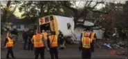  ?? THE ASSOCIATED PRESS ?? In a photo provided by the Chattanoog­a Fire Department via the Chattanoog­a Times Free Press, Chattanoog­a Fire Department personnel work the scene of Tuesday’s fatal elementary school bus crash in Chattanoog­a, Tenn.