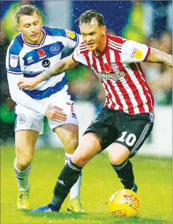  ??  ?? CHALLENGE: Brentford’s Josh McEachran and Rangers’ Luke Freeman compete in midfield