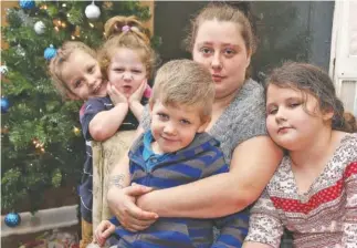  ?? STAFF PHOTO BY ERIN O. SMITH ?? From left, Shianne Everett, 7, Andrew Sky Merritt, 4, Konner Merritt, 7, Natasha McCarty and Jahnomie Everett, 9, pose at their Chattanoog­a home. Natasha and her family received help from the Chattanoog­a Times Free Press Neediest Cases Fund to assist...