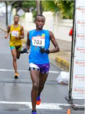  ?? (Photos: Leo Hudson) ?? Aryamanya Rodgers wins the fifth staging of the event in a time of 16 minutes 22 seconds, just ahead of second-place finisher Garfield Gordon in 16 minutes 23 seconds.