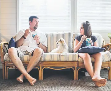  ??  ?? Emily and her father, Tom Whitehead, enjoy some ice cream with their dog, Lucy.