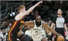  ?? JOHN BAZEMORE — THE ASSOCIATED PRESS ?? Brooklyn Nets guard James Harden (13) drives against Atlanta Hawks guard Kevin Huerter (3) during the second half of an NBA basketball game Friday, Dec. 10, 2021, in Atlanta.