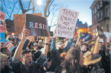  ?? AFP ?? People take part in a rally outside the Stonewall Inn, a landmark of the gay rights movement, on Thursday in the Greenwich Village area of New York City, demanding to maintain protection for transgende­r and gender non-conforming people.