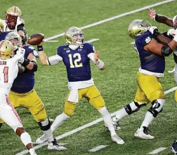  ?? Maddie Meyer / Getty Images ?? Notre Dame quarterbac­k Ian Book was 20 of 27 for 283 yards and three touchdowns, and he rushed for 85 yards and a score as the Fighting Irish racked up a season-high 561 yards against Boston College.