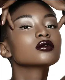  ??  ?? Model wearing plum coloured lipstick.