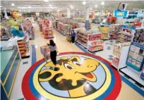  ?? ASSOCIATED PRESS FILE PHOTO ?? A woman pushes a shopping cart over a graphic of Toys R Us mascot Geoffrey the giraffe at the Toys R Us store in Raritan, N.J., in 1996. Toys R Us CEO David Brandon told employees Wednesday the company’s plan is to liquidate all of its U.S. stores,...