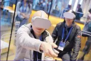  ??  ?? People attending the Facebook conference on Tuesday try the new Oculus Go goggles.