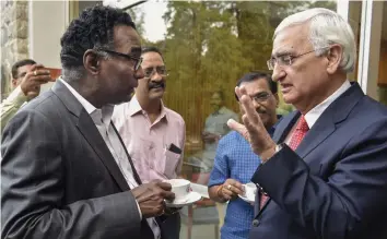  ?? — PTI ?? Supreme Court judge Justice Jasti Chelameswa­r talks to Congress senior leader Salman Khurshid during the book launch ' Appointmen­t of Judges to the Supreme Court of India' in New Delhi, on Monday.