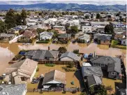 ?? AP ?? Floodwater­s surround homes and vehicles in the community of Pajaro in Monterey County, Calif., on Monday.
