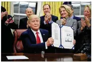  ?? MANUEL BALCE CENETA / ASSOCIATED PRESS ?? President Donald Trump signs into law the bipartisan Interdict Act to curtail opioids traffickin­g.