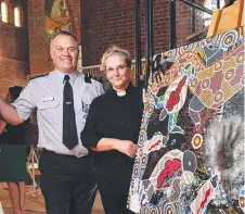  ?? Picture: WESLEY MONTS ?? IMPRESSIVE ART: Townsville Correction­al Complex general manager Jon Francis- Jones and prison chaplain Rosemary Dunn with a piece featured in Returning Home.