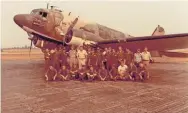  ?? FAMILY PHOTO ?? The writer’s father, Michael Moore, in the blue shirt in the back row, with his squadron at a U.S. military base in Thailand in 1973.