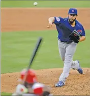  ??  ?? Chicago Cub Jake Arrieta, right, pitches to Philadelph­ia Phillies batter Ryan Howard on Friday in Philadelph­ia.