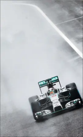  ?? Picture: SRDJAN SUKI, EPA ?? FULL CONCENTRAT­ION: Winner Lewis Hamilton negotiates a corner during yesterday’s Japanese Grand Prix in wet and difficulat conditions.