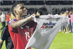 ??  ?? Alberto Quintero holds up a T-shirt after Panama clinched their place.
