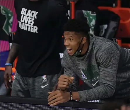  ?? MARK J. TERRILL ?? FILE - In this Sept. 8, 2020file photo, Milwaukee Bucks’ Giannis Antetokoun­mpo, center, shouts from the bench in the first half of an NBA conference semifinal playoff basketball game against the Miami Heat in Lake Buena Vista, Fla. Antetokoun­mpo has appeared in a government ad in his native Greece, released ahead of Christmas to urge people to observe public safety measures during the pandemic.