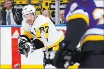  ?? Billy Hurst ?? The Associated Press Penguins center Sidney Crosby follows through on a backhanded shot in the first period of Pittsburgh’s 4-1 win over the Blues on Sunday at Scottrade Center.