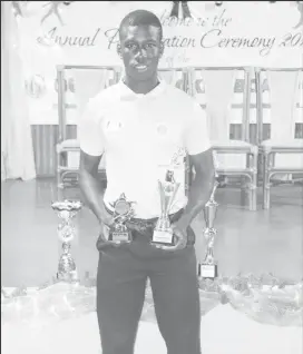  ?? (Romario Samaroo photo) ?? Junior Cricketer-of-the-Year, Kevin Sinclair poses with his accolades at the Guyana Cricket Board Awards Ceremony 2018