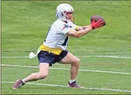  ??  ?? New England Patriots wide receiver Julian Edelman catches a pass during a drill at NFL football practice in Foxborough, Mass., on Thursday.