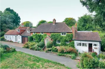  ?? ?? Pretty Tudor Cottage has seen various alteration­s over the centuries and offers almost 5,000sq ft of living space on the edge of the South Downs in West Sussex. £2.25m