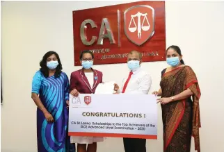  ??  ?? CA Sri Lanka Vice President Mr. Sanjaya Bandara presenting a scholarshi­p to island third Ms. Khulusie Naadiya Mariam of Devi Balika Vidyalaya in the presence of Chief Executive Officer of CA Sri Lanka Ms. Dulani Fernando.